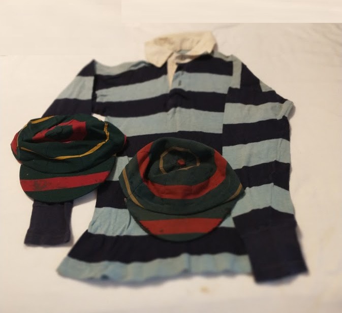 2021 photo of a rugby shirt and school caps from Queen Mary's Grammar School